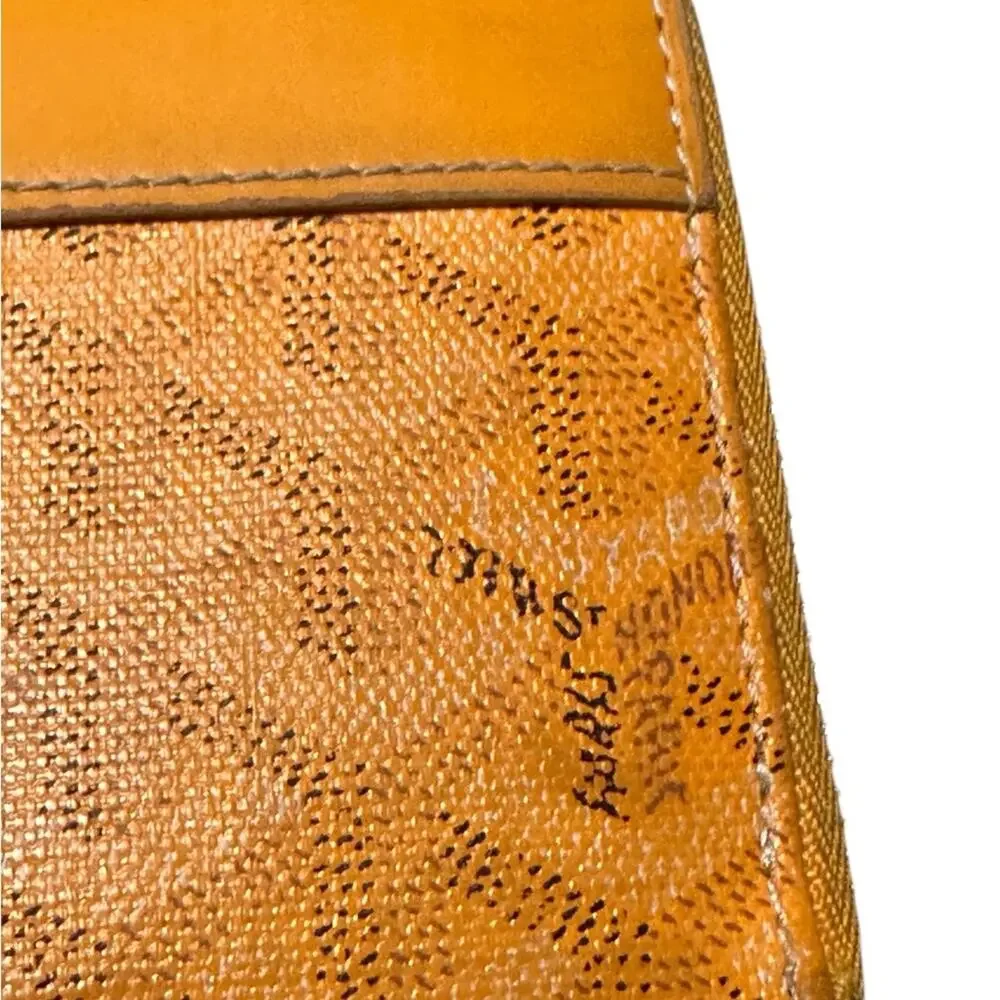 Goyard Matignon zip-around wallet in yellow orange Goyardine canvas.